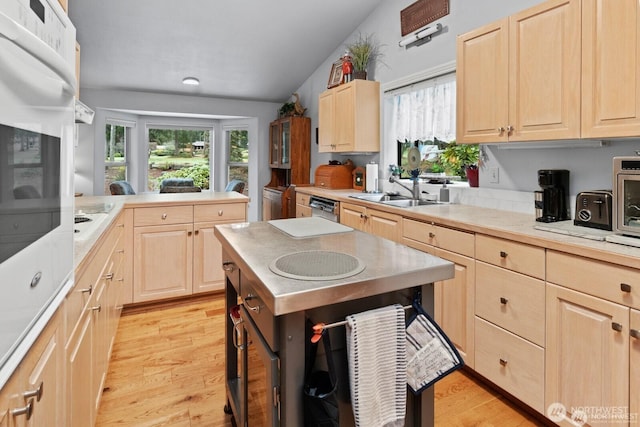 kitchen featuring light brown cabinets and a sink