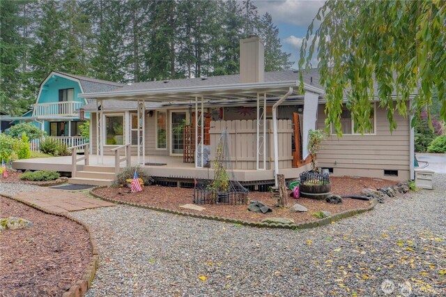 view of front facade featuring crawl space, a porch, a chimney, and a shingled roof