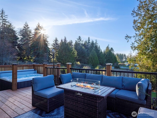 wooden deck with an outdoor living space with a fire pit