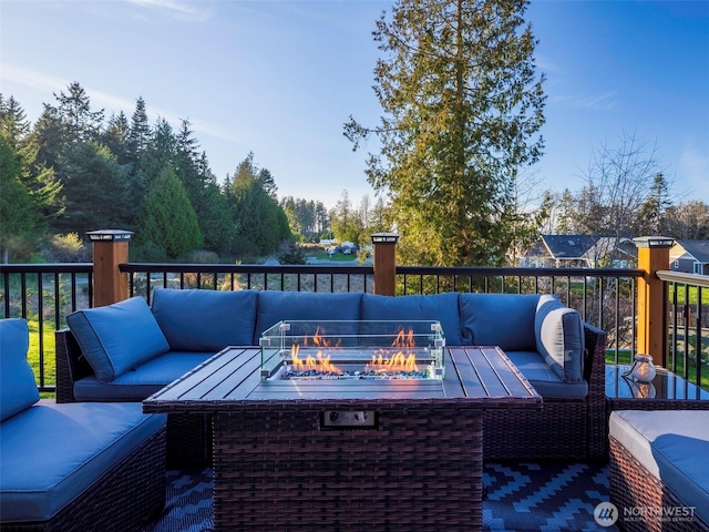 wooden deck with an outdoor living space with a fire pit