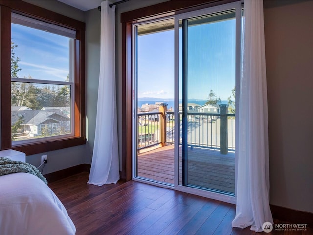 bedroom with wood finished floors and access to outside