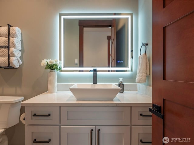 bathroom with toilet and vanity