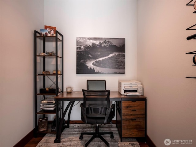 office area with baseboards and dark wood-style flooring