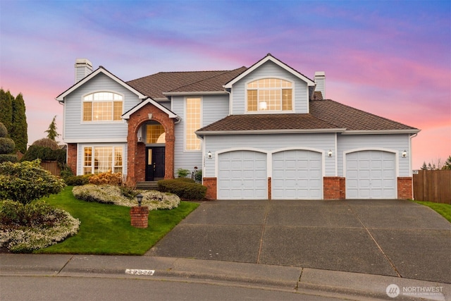 view of front of home featuring brick siding, concrete driveway, a chimney, and fence