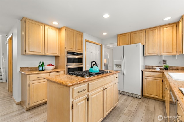 kitchen with light brown cabinets, a kitchen island, light wood-type flooring, recessed lighting, and stainless steel appliances