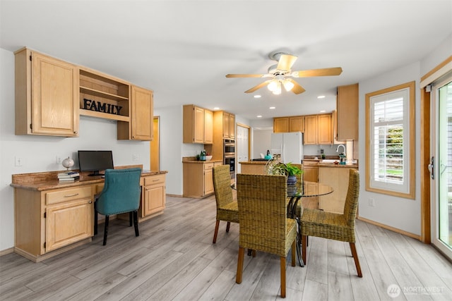 dining room with baseboards, light wood-type flooring, built in desk, recessed lighting, and a ceiling fan