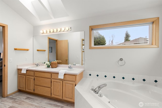 full bathroom with a bath, double vanity, wood finished floors, and vaulted ceiling