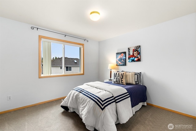 carpeted bedroom featuring baseboards