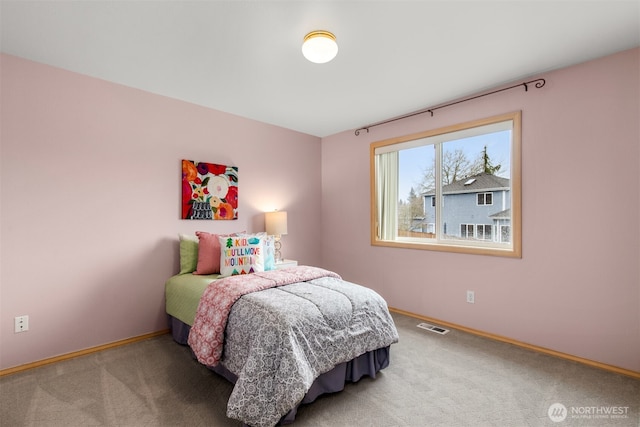 carpeted bedroom featuring visible vents and baseboards