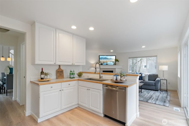 kitchen featuring open floor plan, dishwasher, recessed lighting, a peninsula, and a sink