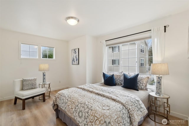 bedroom with wood finished floors and baseboards