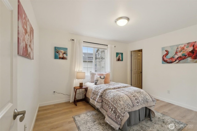 bedroom featuring baseboards and light wood-style floors