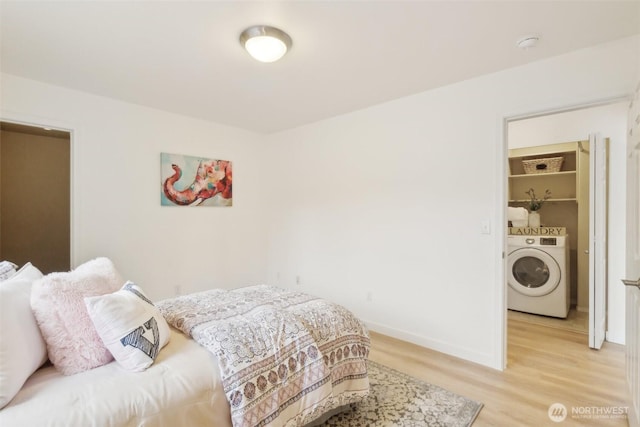 bedroom with baseboards, washer / clothes dryer, and light wood finished floors