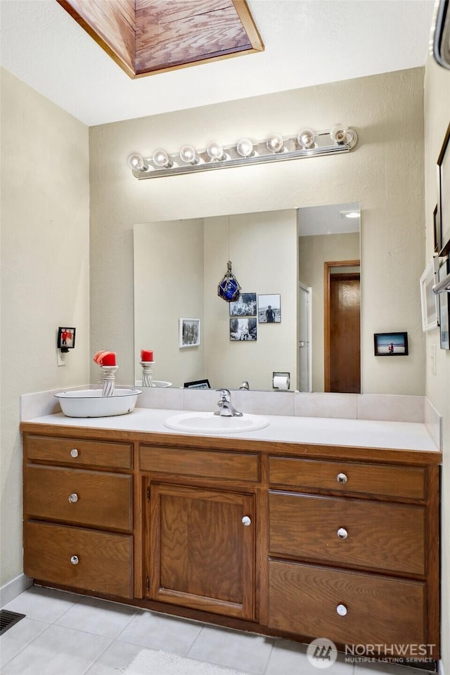 bathroom with tile patterned floors, visible vents, and vanity