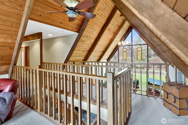 hallway featuring lofted ceiling with beams, wood ceiling, and carpet floors