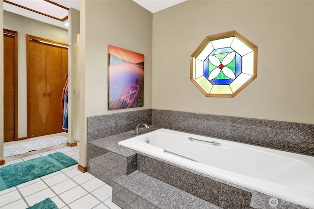 bathroom with tile patterned flooring and a garden tub