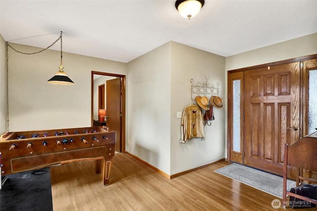 foyer entrance with light wood-type flooring and baseboards