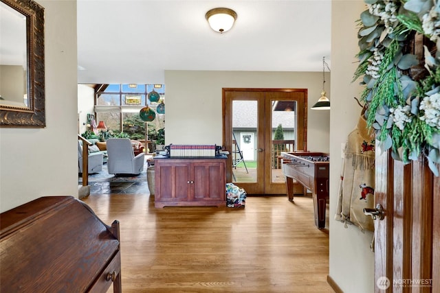 foyer featuring light wood-style flooring, french doors, and a wealth of natural light