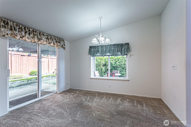 carpeted spare room with baseboards, lofted ceiling, and an inviting chandelier