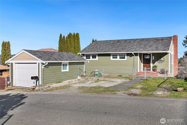 view of front of home with an outbuilding, a gate, fence, a garage, and a chimney