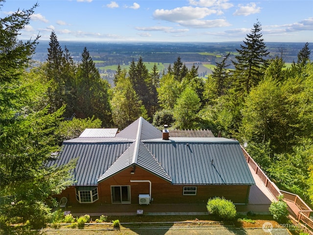 birds eye view of property with a view of trees