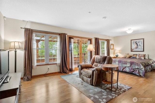 bedroom with light wood-type flooring and baseboards