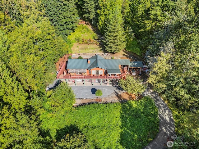 birds eye view of property with a view of trees