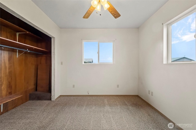 unfurnished bedroom featuring carpet flooring, a ceiling fan, and baseboards