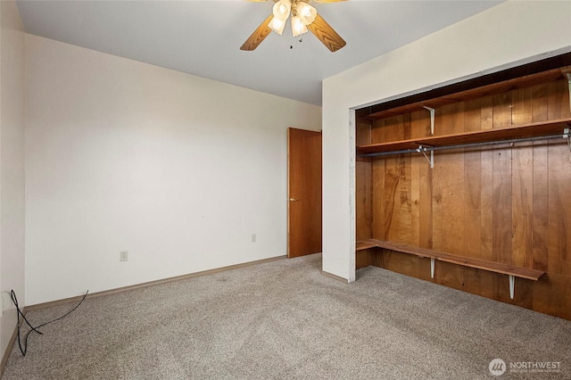 unfurnished bedroom featuring a closet, a ceiling fan, baseboards, and carpet floors