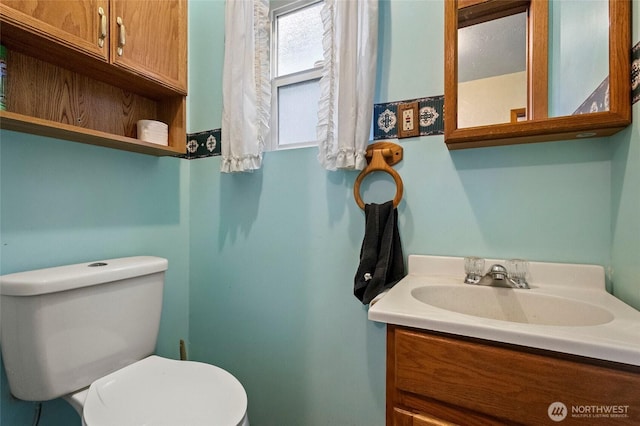 bathroom featuring toilet and vanity