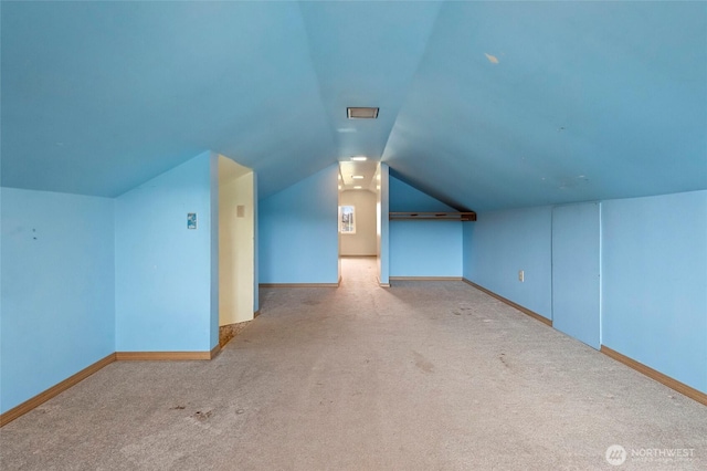 bonus room with vaulted ceiling, carpet, and baseboards