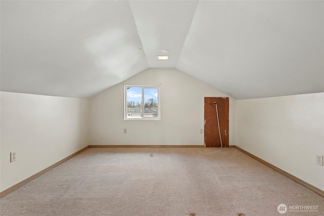 bonus room featuring baseboards, carpet flooring, and vaulted ceiling