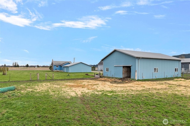 exterior space featuring an outbuilding and fence