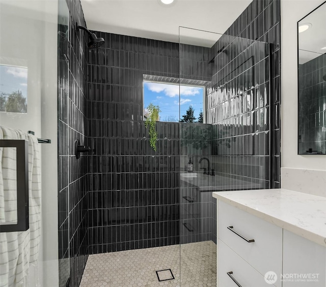 full bathroom featuring a walk in shower and vanity