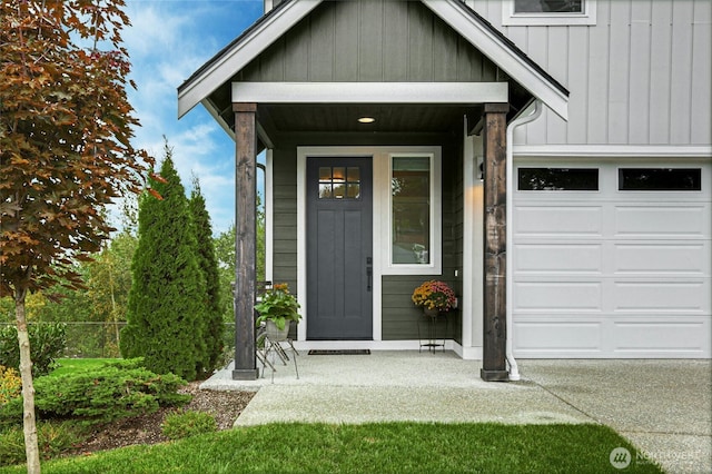 entrance to property featuring a garage and board and batten siding