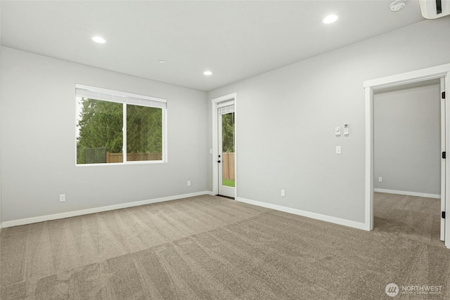 carpeted empty room with recessed lighting and baseboards