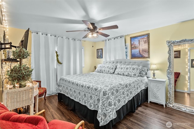 bedroom with a ceiling fan and dark wood-style flooring