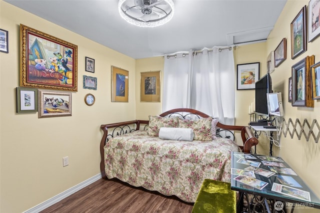 bedroom with baseboards and wood finished floors