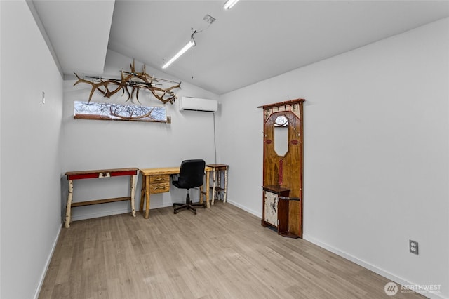 office area featuring baseboards, a wall mounted AC, lofted ceiling, and wood finished floors