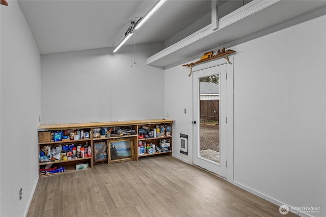 recreation room with baseboards and wood finished floors