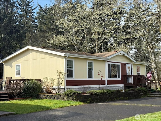 view of home's exterior with crawl space and a yard