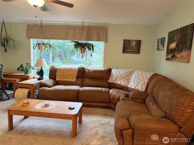 carpeted living area with lofted ceiling and ceiling fan