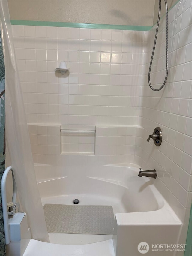 bathroom with shower / bath combination with curtain