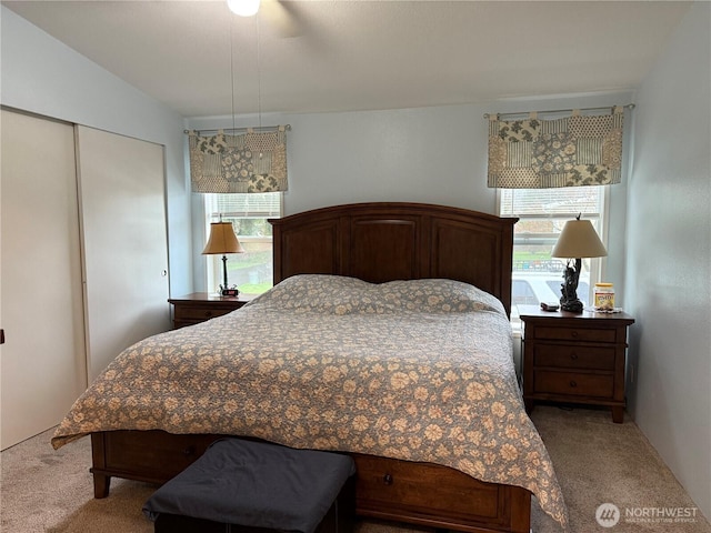 carpeted bedroom with a ceiling fan and a closet