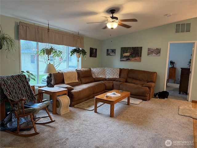 carpeted living area with vaulted ceiling, a ceiling fan, and visible vents