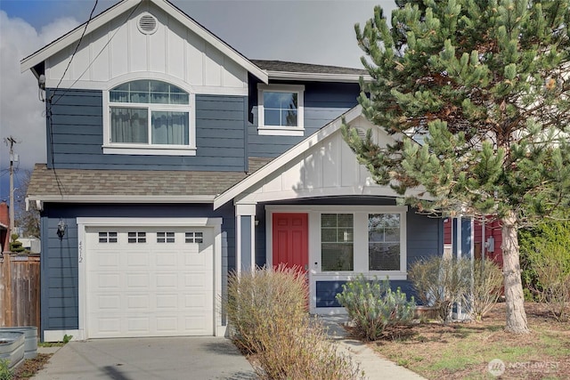 view of front of home with concrete driveway, an attached garage, board and batten siding, and roof with shingles