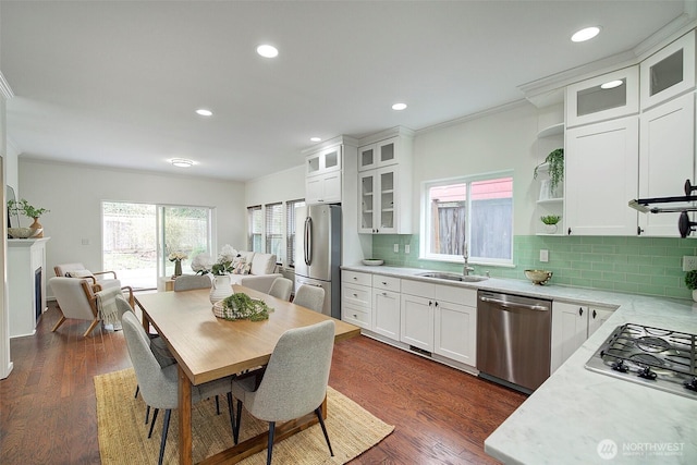 dining room featuring recessed lighting, dark wood-style flooring, and ornamental molding