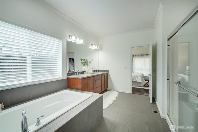 bathroom featuring tile patterned flooring, ensuite bath, crown molding, and a sink