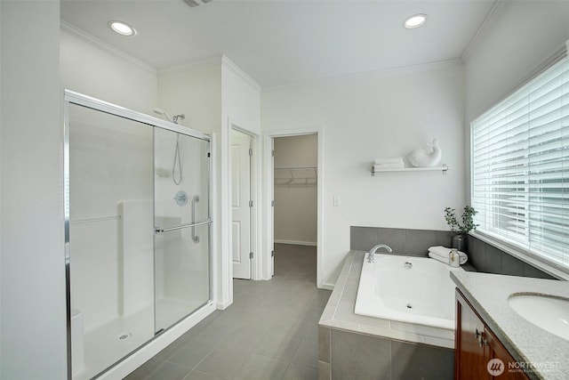 full bath with a garden tub, a stall shower, a spacious closet, and ornamental molding