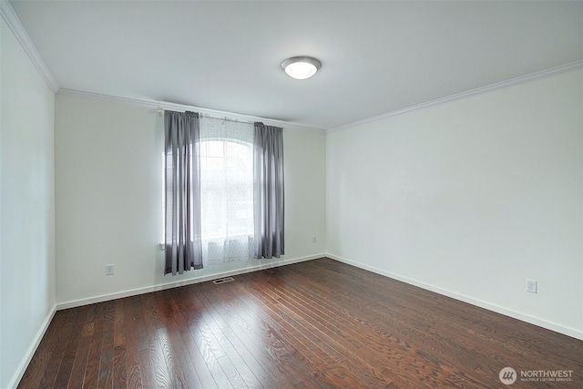 unfurnished room with dark wood-type flooring, crown molding, visible vents, and baseboards